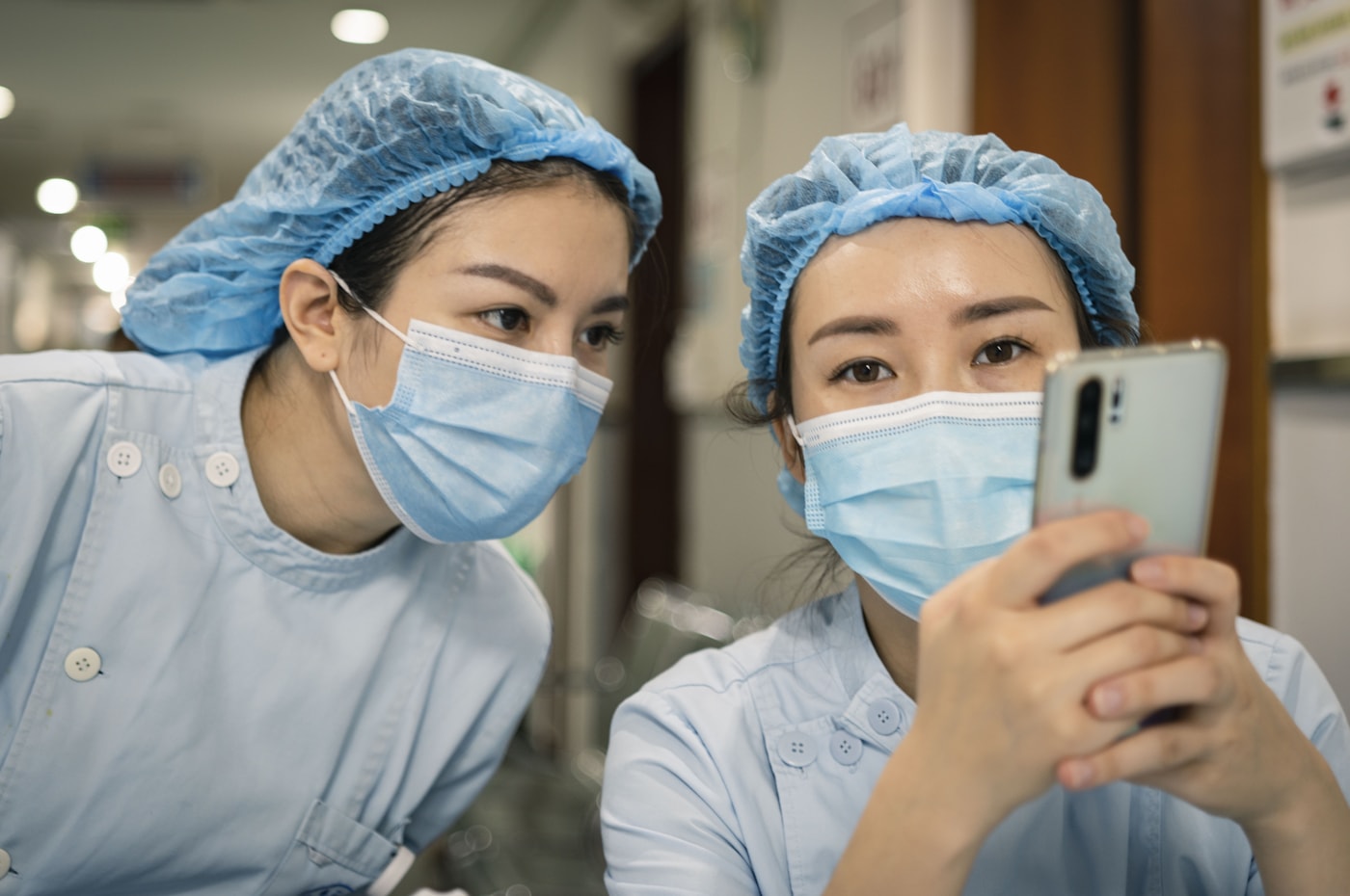 Chinese nurses reviewing patient information in a clinic